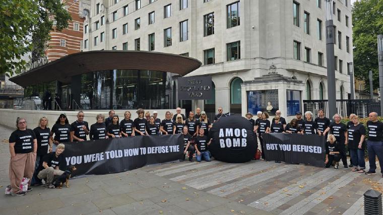 A photo of people protesting outside New Scotland Yard in London